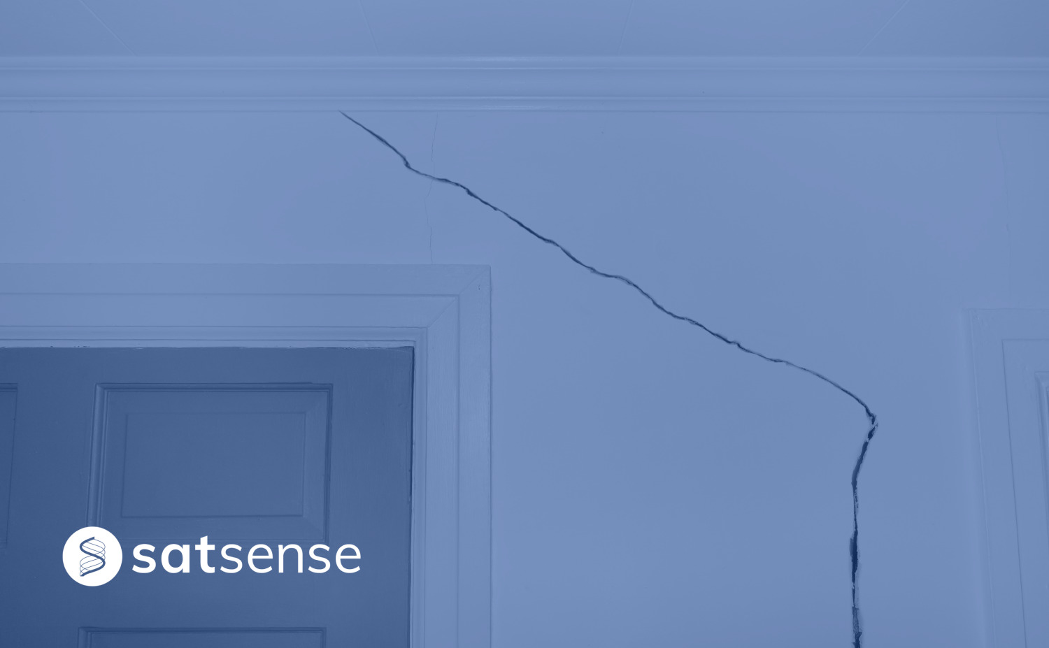 Cracks on the wall of a house with SatSense logo on the bottom left corner