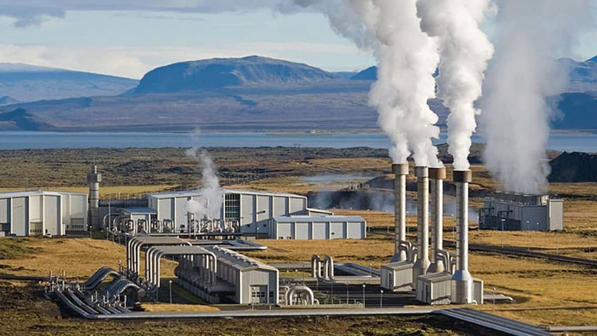 Geothermal power plant releasing steam in a volcanic region, demonstrating the importance of InSAR monitoring for energy infrastructure stability